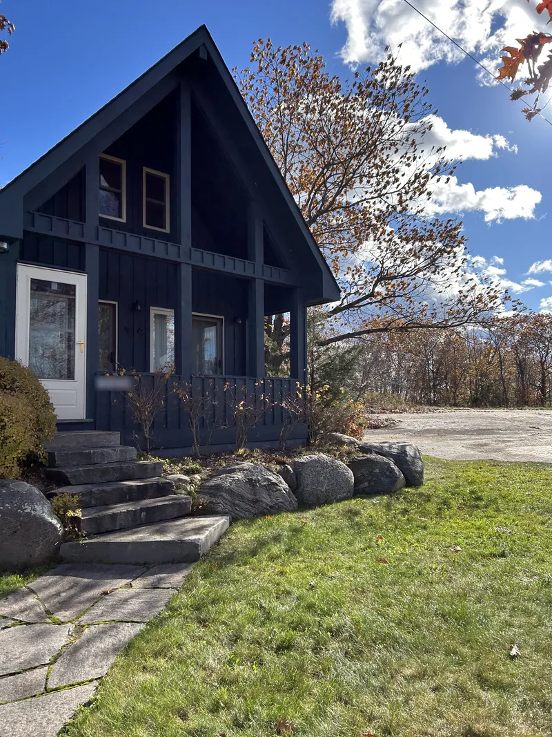A-frame cottage lawn and stone steps after a True North fall cleanup